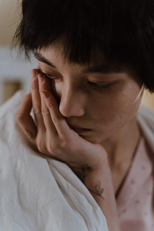 A young woman appearing deeply distressed.
