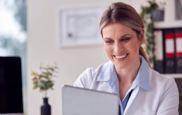 Patient using a laptop to communicate with a doctor during an online consultation