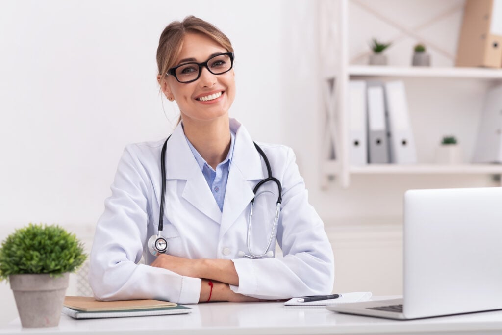 Patient attending an online medical consultation with a doctor using a laptop at home