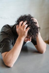 A man looking overwhelmed and stressed.
