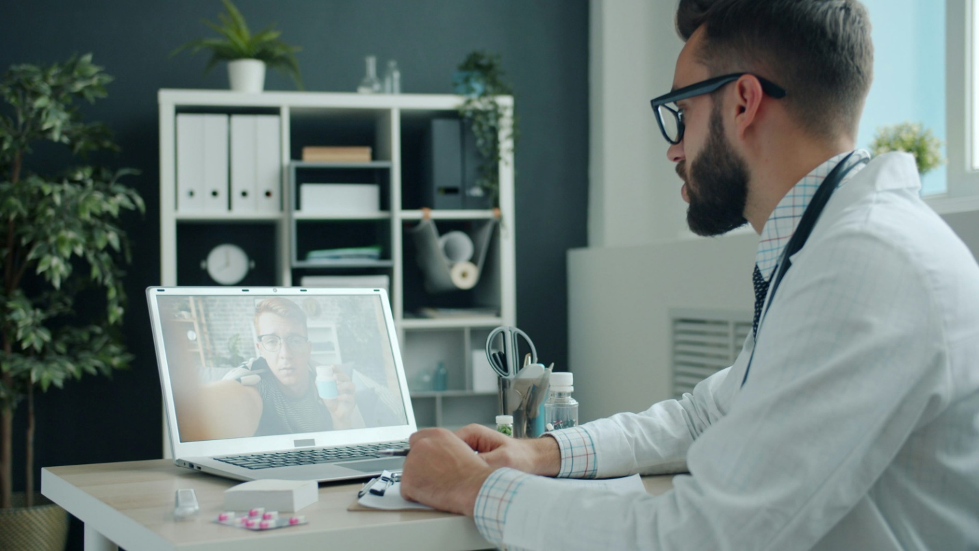 A doctor consulting with a patient online