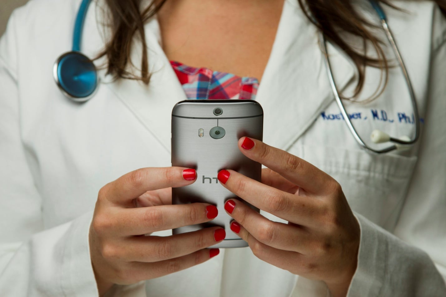 A doctor holding her phone