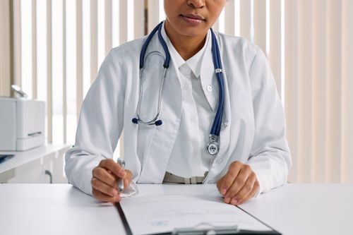Doctor working in a medical office and reviewing patient documentation.