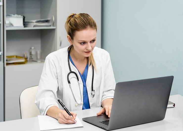 Doctor preparing medical documentation during an online patient consultation.