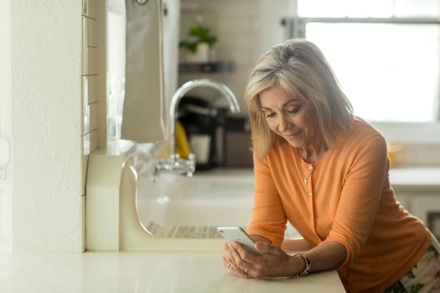 An old woman looking at her phone