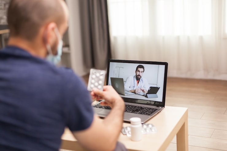Patient discussing symptoms and medication with a virtual doctor during an online appointment.