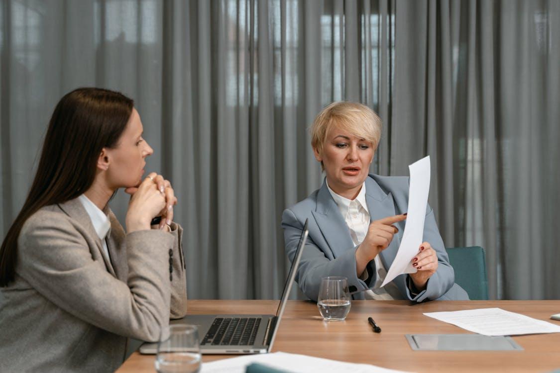 A person showing a document to another person during a meeting