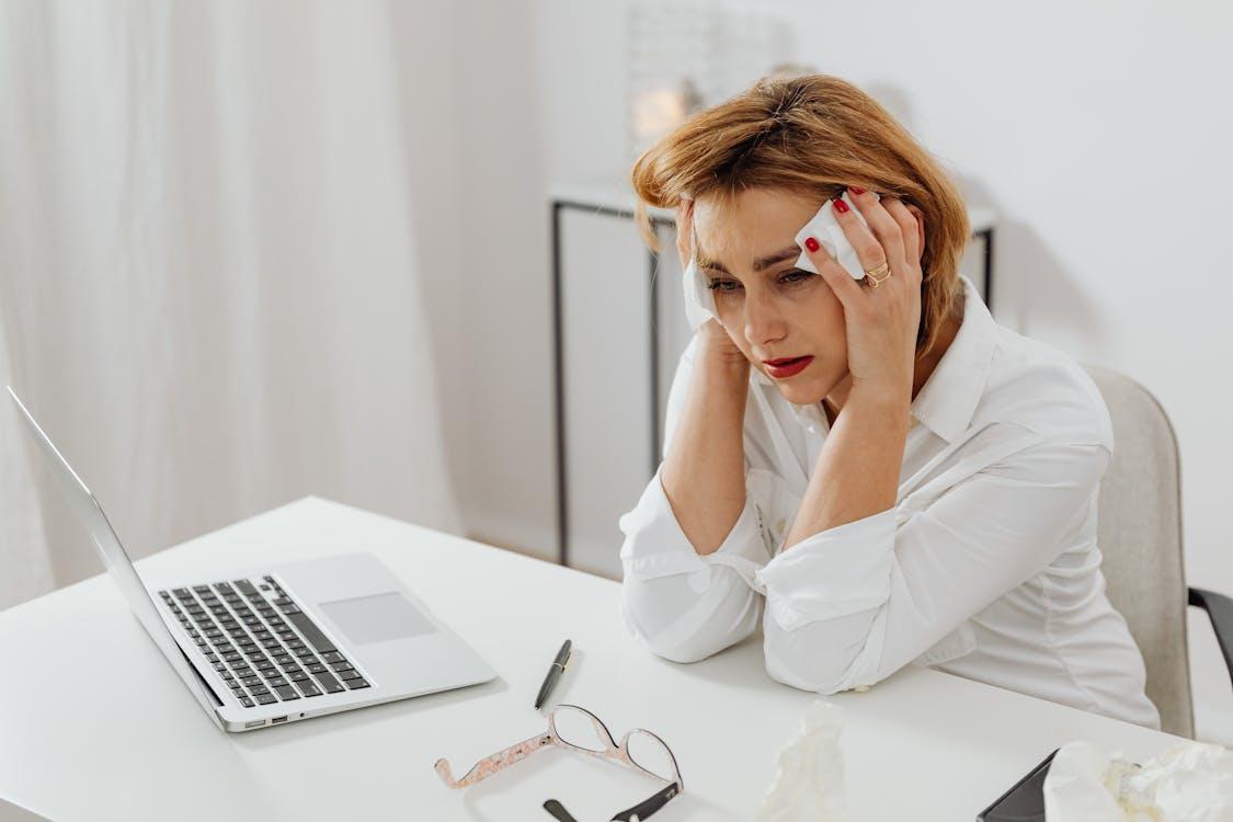 A person holding her head and crying