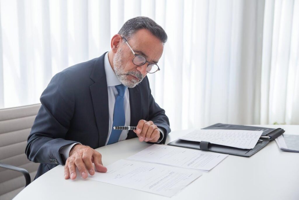 An executive reviewing papers in a file