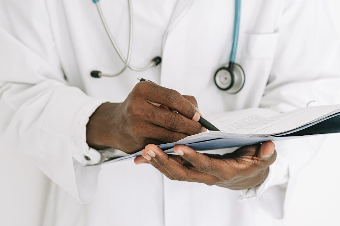 A healthcare professional holding a pen and paper