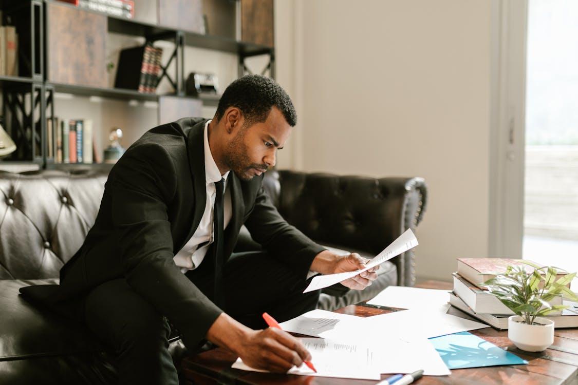 An executive reviewing papers while sitting on a couch