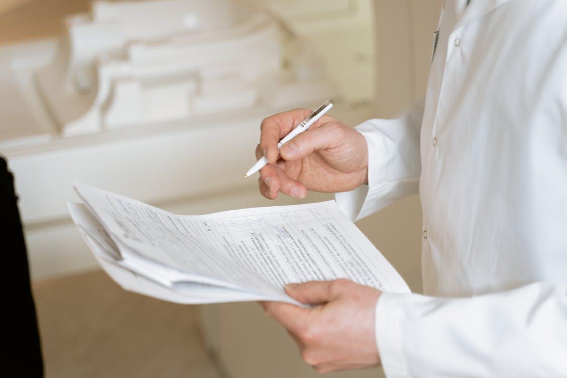A person holding a pen and paper