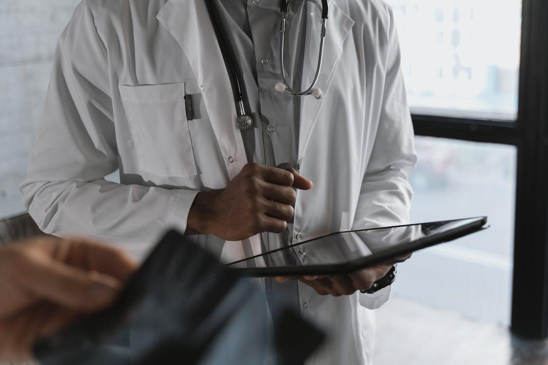 A healthcare professional holding a tablet
