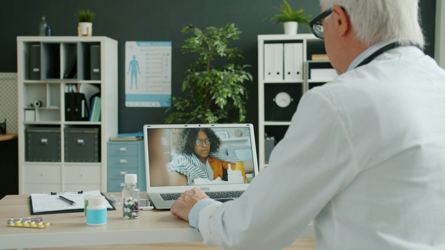 A doctor consulting with a patient over video call