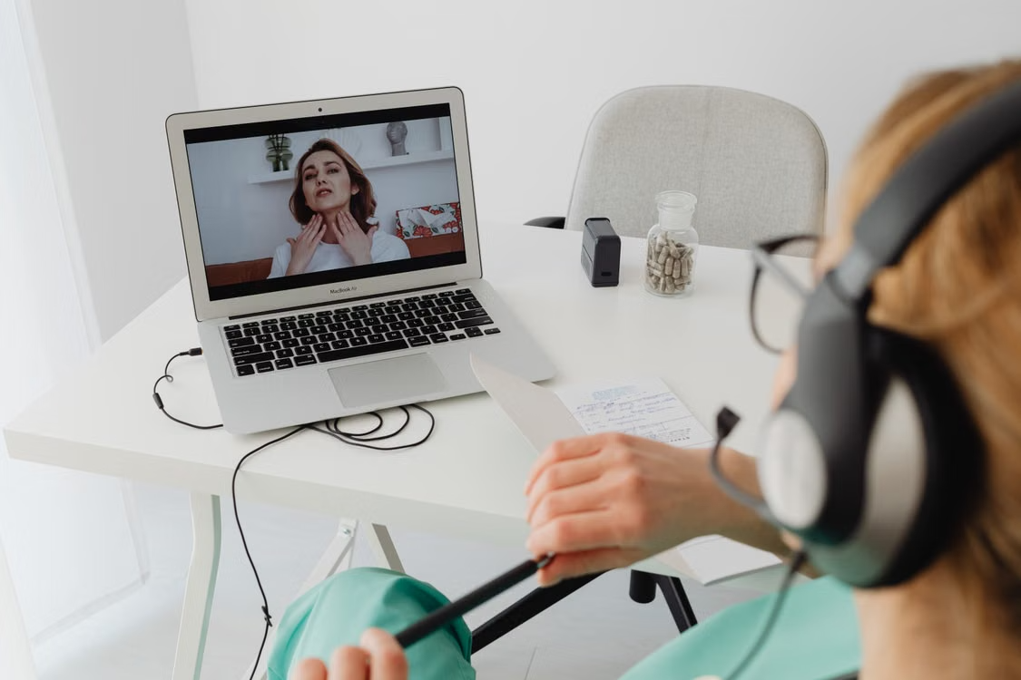 Healthcare provider video conferencing with a patient during an online consultation