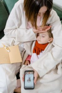 Parent assessing a child's symptoms at home and deciding between emergency and telehealth care