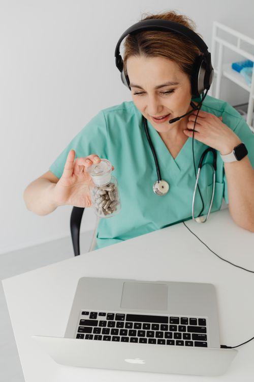 Healthcare provider reviewing medication during an online prescription refill consultation
