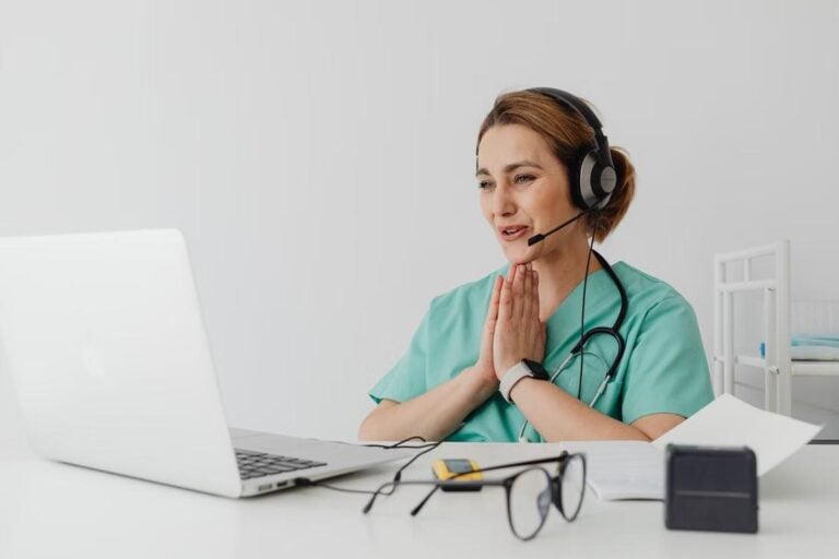 Nurse conducting a telehealth urgent care consultation with a patient on a laptop